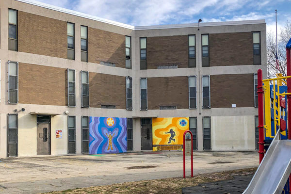 Exterior photo of Cook Wissahickon School. Premier Building Restoration crew completed concrete patching, concrete coating, brick replacement, brick pointing, caulking, and facade cleaning to transform and protect the building.